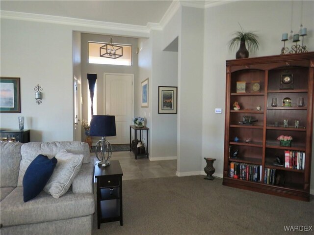 living area featuring carpet floors, baseboards, and ornamental molding