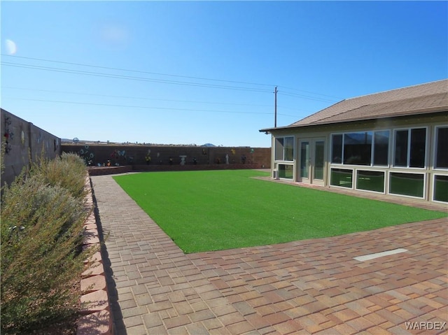 view of yard with fence and a patio