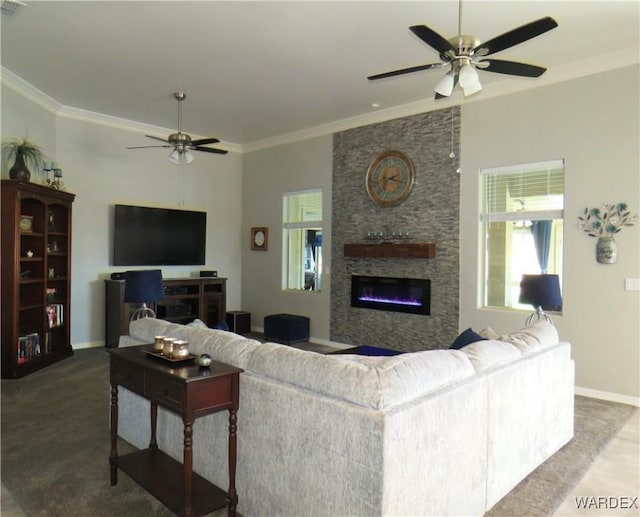 living room featuring baseboards, a ceiling fan, carpet, crown molding, and a fireplace