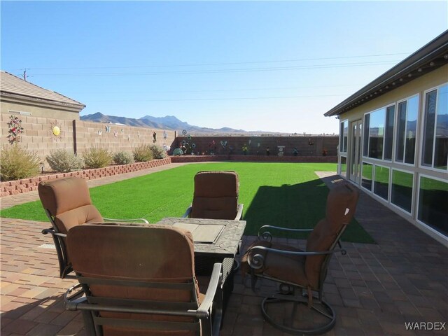 view of patio featuring a fenced backyard and a mountain view