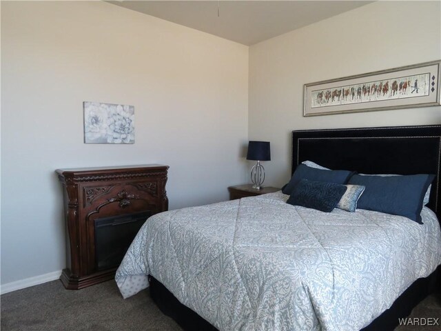 carpeted bedroom featuring baseboards