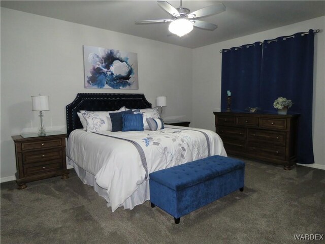 bedroom featuring ceiling fan, baseboards, and dark colored carpet