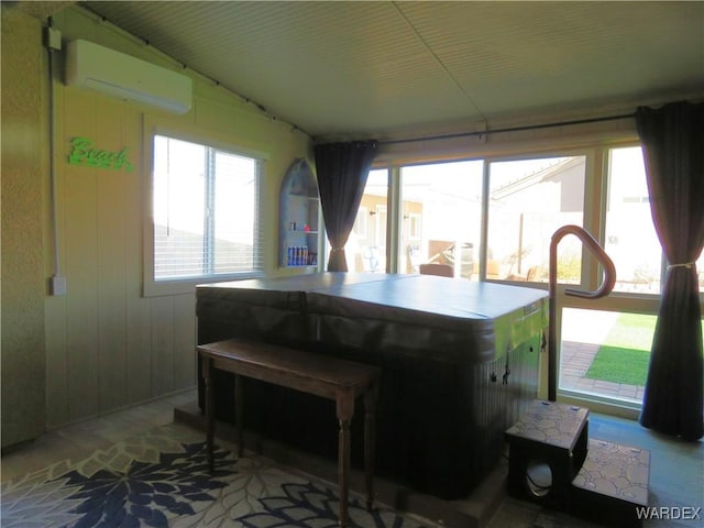 kitchen with a wall mounted AC and a wealth of natural light