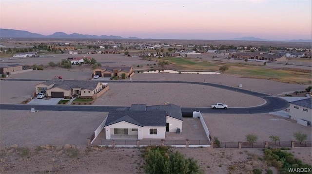 aerial view at dusk featuring a residential view