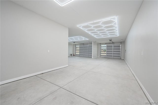 empty room featuring concrete floors and baseboards