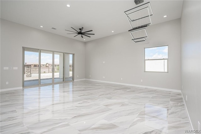 spare room featuring marble finish floor, baseboards, a ceiling fan, and recessed lighting