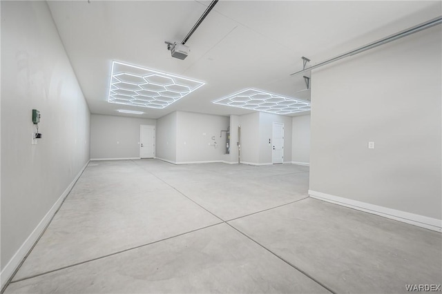 garage with baseboards, electric water heater, and a garage door opener