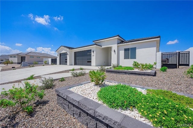 view of front of home with a garage, a residential view, driveway, and stucco siding