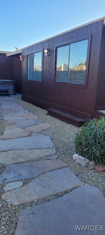 view of home's exterior featuring a patio and fence