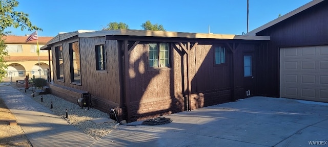 view of home's exterior with concrete driveway