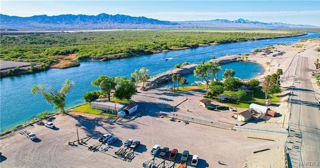 drone / aerial view featuring a water and mountain view