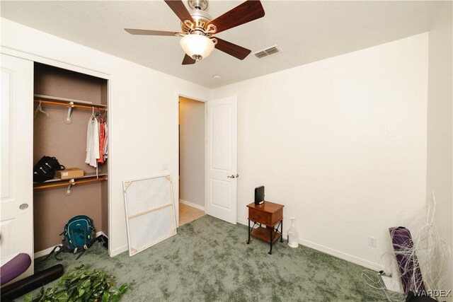 unfurnished bedroom featuring visible vents, baseboards, ceiling fan, carpet, and a closet