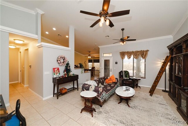 living room with ornamental molding, light tile patterned flooring, and baseboards