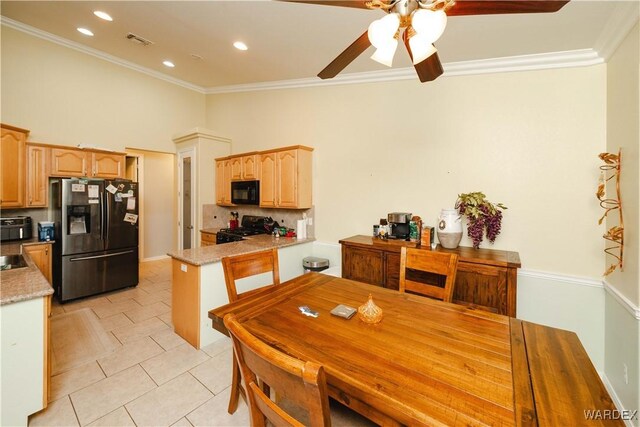 kitchen featuring visible vents, stove, light countertops, black microwave, and stainless steel refrigerator with ice dispenser