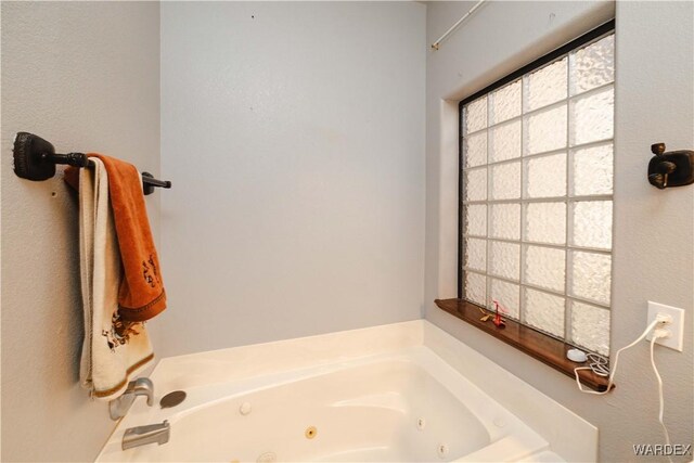 full bathroom with a whirlpool tub