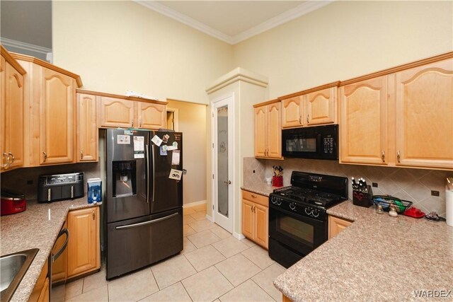 kitchen featuring black appliances, ornamental molding, backsplash, and light countertops