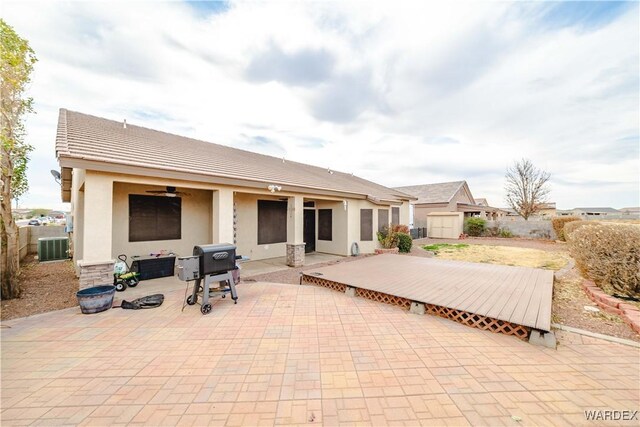 back of property with a patio, central air condition unit, fence, a ceiling fan, and stucco siding