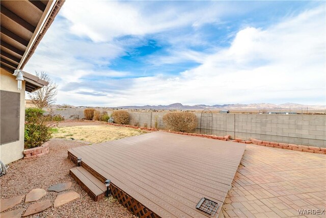 view of patio / terrace featuring a fenced backyard and a mountain view