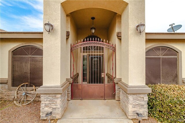 property entrance with stucco siding