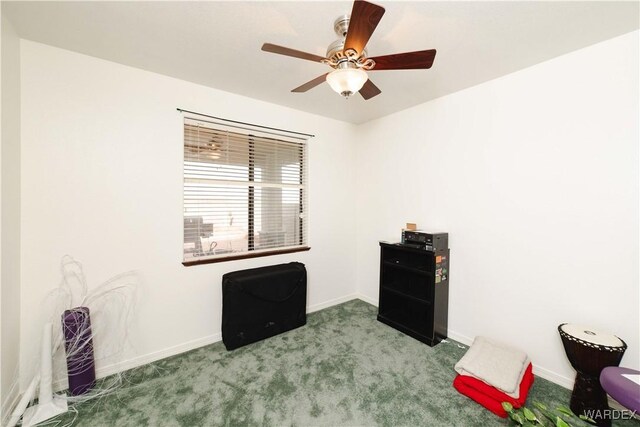 interior space with light colored carpet, ceiling fan, and baseboards