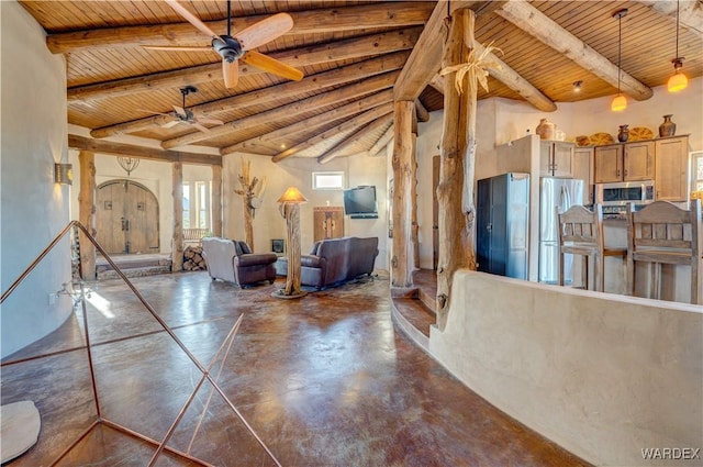 living area with wooden ceiling, beamed ceiling, a ceiling fan, and finished concrete floors