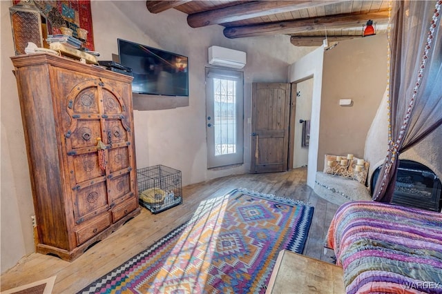 foyer entrance with wood ceiling, beam ceiling, an AC wall unit, and hardwood / wood-style flooring