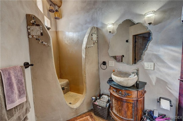 bathroom with vanity and a shower stall