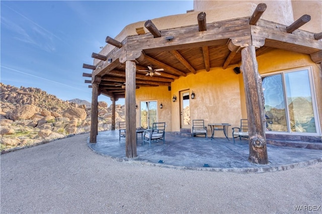 view of patio / terrace featuring a mountain view and a ceiling fan