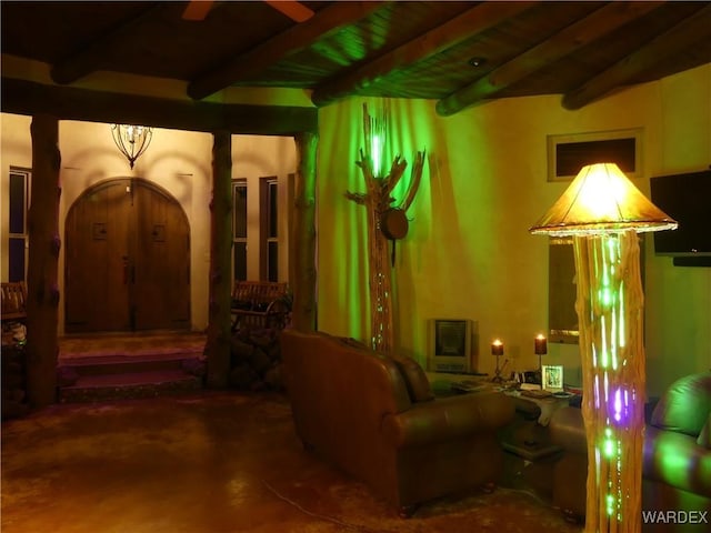 interior space with heating unit, beam ceiling, wood ceiling, and ceiling fan