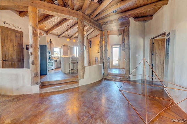 foyer featuring wood ceiling, beam ceiling, finished concrete flooring, and high vaulted ceiling