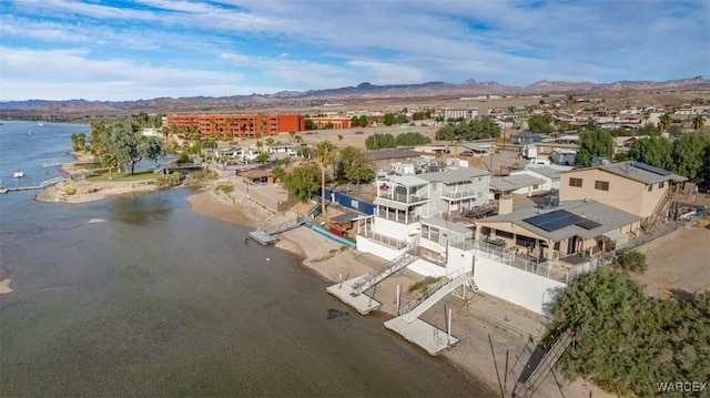 drone / aerial view with a water view and a residential view