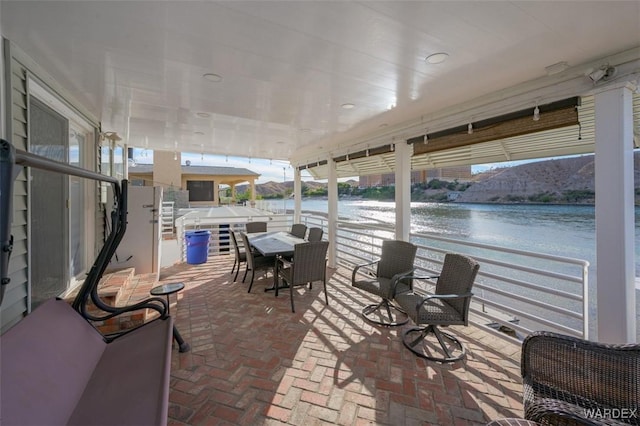 view of patio with a water view