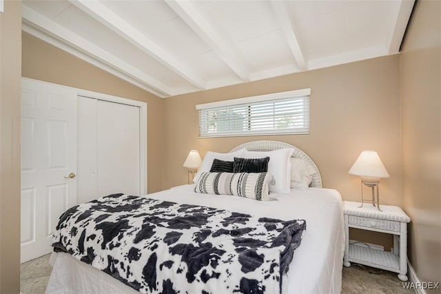 bedroom featuring lofted ceiling with beams and a closet