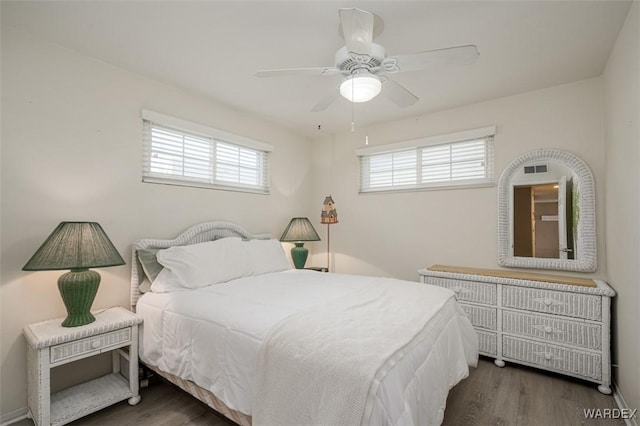 bedroom with ceiling fan and dark wood finished floors