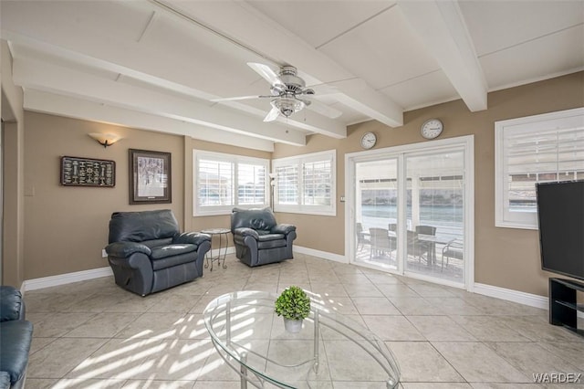 living room featuring light tile patterned floors, ceiling fan, baseboards, and beam ceiling