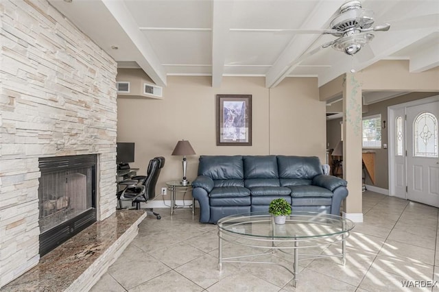 living room with light tile patterned floors, beam ceiling, and visible vents