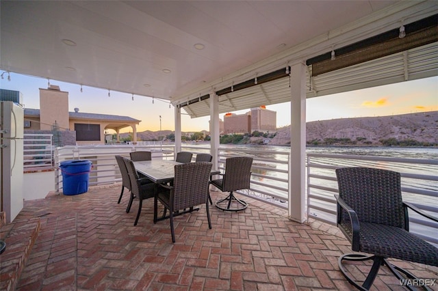 patio terrace at dusk with outdoor dining area