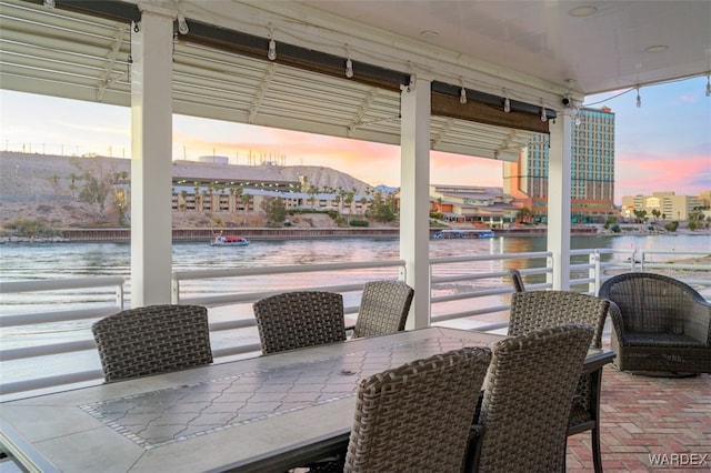 view of patio / terrace with a water view and a bar