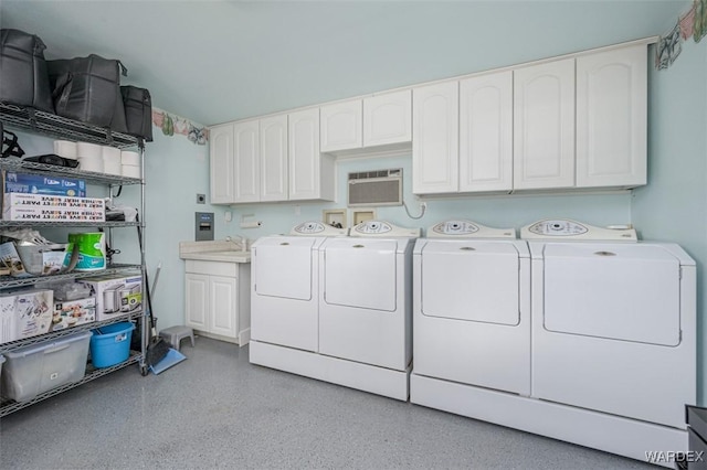 laundry area featuring washer and clothes dryer, a wall mounted air conditioner, a sink, and cabinet space