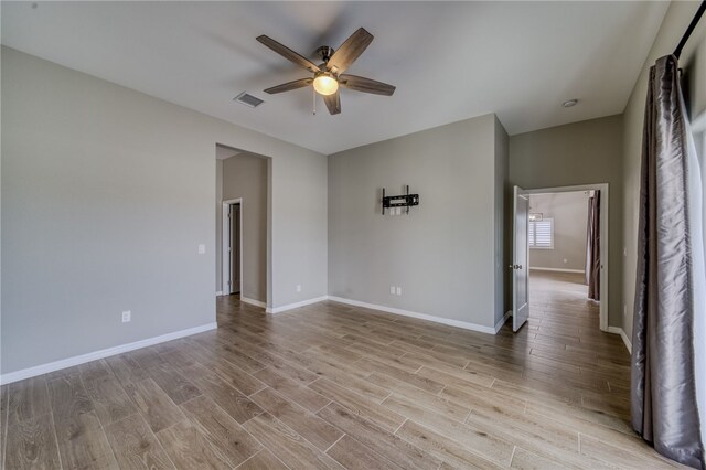 2339 E Calle Madrid, Fort Mohave, AZ 86426 - empty room with ceiling fan, light wood-type flooring, and baseboards