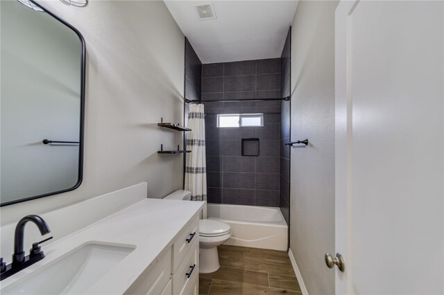 2339 E Calle Madrid, Fort Mohave, AZ 86426 - bathroom with toilet, vanity, wood finished floors, baseboards, and shower / bathtub combination with curtain