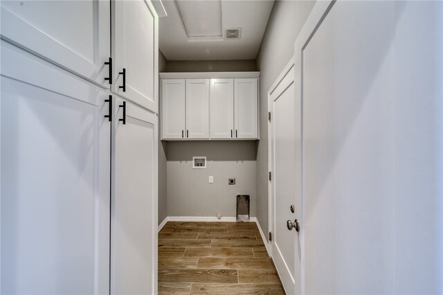 2339 E Calle Madrid, Fort Mohave, AZ 86426 - clothes washing area featuring hookup for an electric dryer, cabinet space, hookup for a washing machine, light wood finished floors, and baseboards