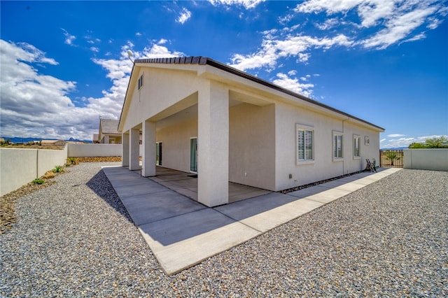 2339 E Calle Madrid, Fort Mohave, AZ 86426 - view of home's exterior featuring a patio area, a fenced backyard, and stucco siding