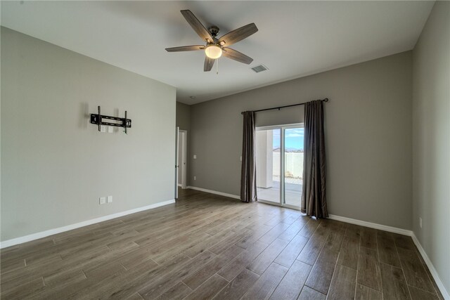 2339 E Calle Madrid, Fort Mohave, AZ 86426 - spare room featuring ceiling fan, dark wood-style flooring, and baseboards