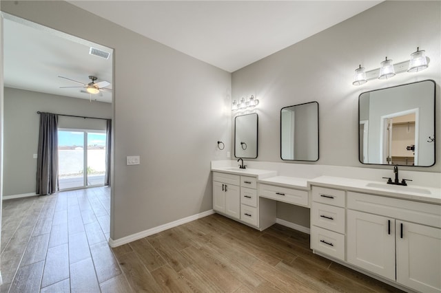 2339 E Calle Madrid, Fort Mohave, AZ 86426 - bathroom with wood finished floors, double vanity, baseboards, and a ceiling fan