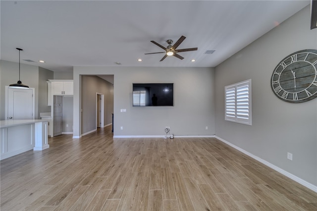 2339 E Calle Madrid, Fort Mohave, AZ 86426 - unfurnished living room featuring a ceiling fan, light wood-type flooring, recessed lighting, and baseboards