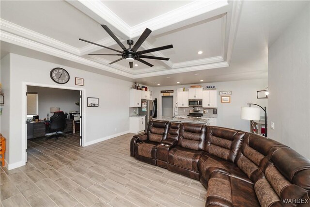 living room featuring ornamental molding, recessed lighting, ceiling fan, and baseboards