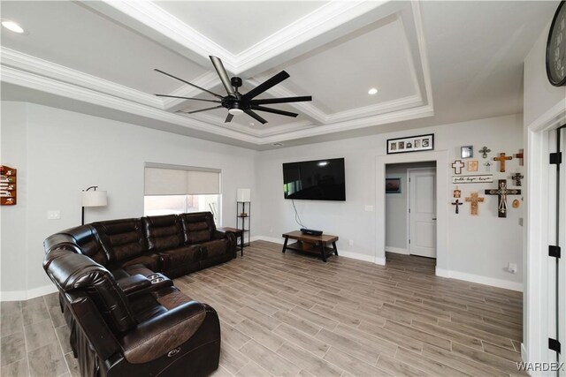 living area featuring ornamental molding, wood tiled floor, coffered ceiling, and ceiling fan