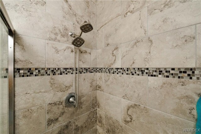 interior details with a tile shower