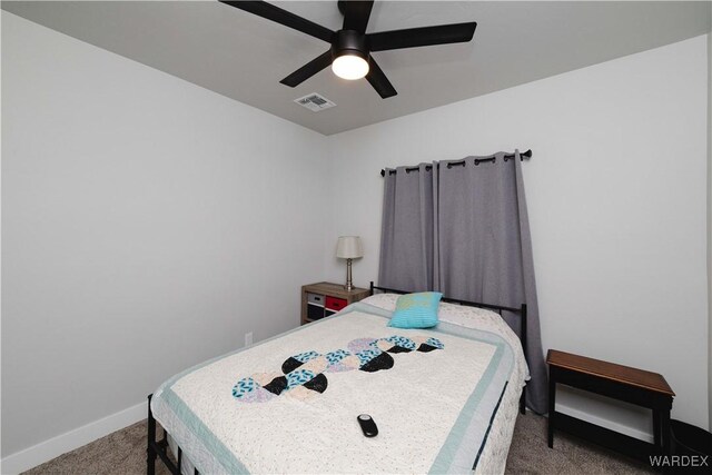 carpeted bedroom with baseboards, visible vents, and a ceiling fan